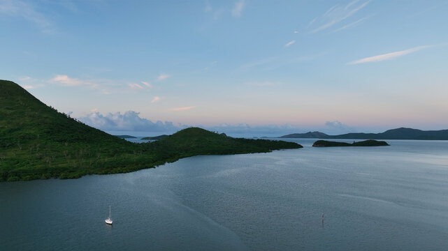 Aerial view of a beautiful tropical archipelago at sunrise with serene waters and lush greenery, Noumea, South Province, New Caledonia.