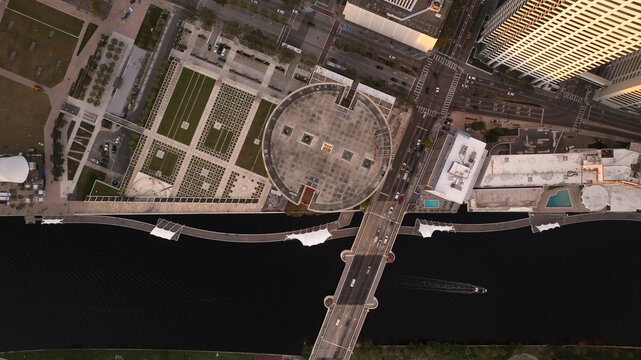 Aerial view of abstract buildings and a bridge with traffic over a river in downtown, Tampa, Florida, United States.