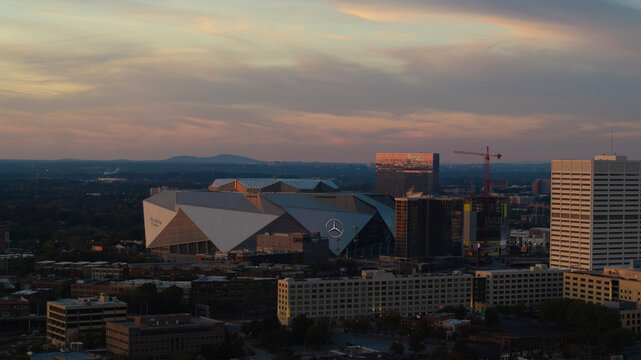 Atlanta, United States - 17 November 2024: Aerial view of mercedes-benz stadium and vibrant skyline at dusk, downtown, atlanta, georgia, united states.