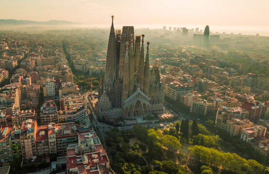 Aerial view of the beautiful Sagrada Familia and modern skyline in Eixample, Barcelona, Spain.