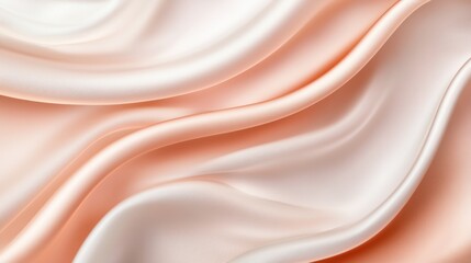 Soft silk fabric drapes elegantly in peach and cream tones, creating a flowing texture that enhances any design or setting during daylight