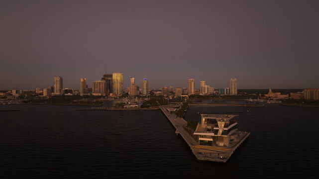 Aerial view of St. Pete Pier at sunrise with a serene skyline and tranquil waterfront, Downtown St. Petersburg, Florida, United States.
