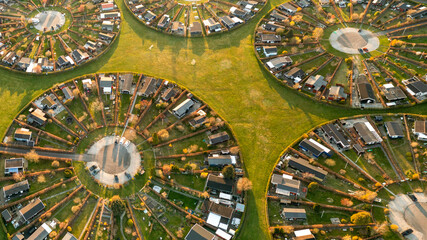 Aerial view of circular housing and gardens in a planned community with geometric patterns, Harekaer, Hovedstaden, Denmark.