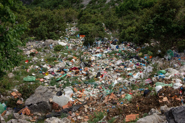 Pollution of the environment. A pile of garbage in nature. Garbage on the mountain. Bad ecology. Pollution of nature