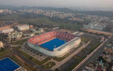 Odisha, India - February 25: Aerial view of a modern stadium surrounded by urban architecture and a green field, Rourkela, Odisha, India.