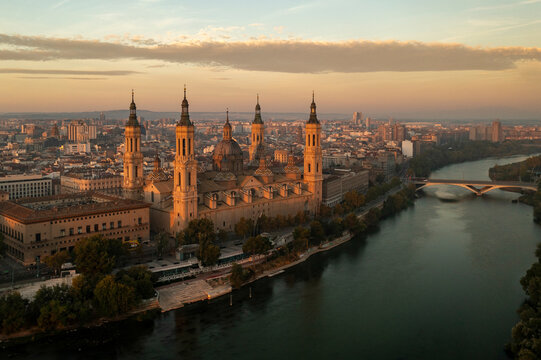 Aerial view of the majestic Cathedral El Pilar at dusk with a picturesque cityscape and river reflection, Zaragoza, Aragon, Spain.