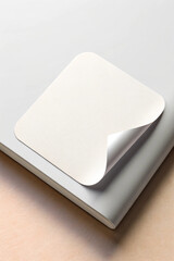 A clean, minimalist white sticker mockup with a blank surface, perfect for branding, logo designs, labels, and product presentation. High-resolution and customizable