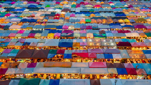 Aerial view of vibrant and bustling Rod Fai Market with colorful stalls and tents, Bangkok, Central Thailand.