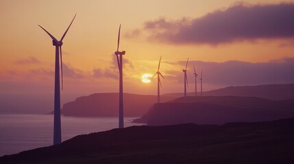 Obraz premium Majestic Sunset Over Wind Turbines by the Sea Landscape View