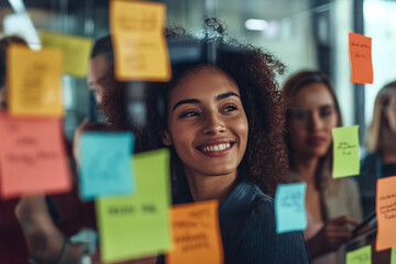 Professional Diverse business team engaging in innovative brainstorming session with colorful sticky notes on glass wall. Creative professionals sharing, discussing, and visualizing ideas using des...
