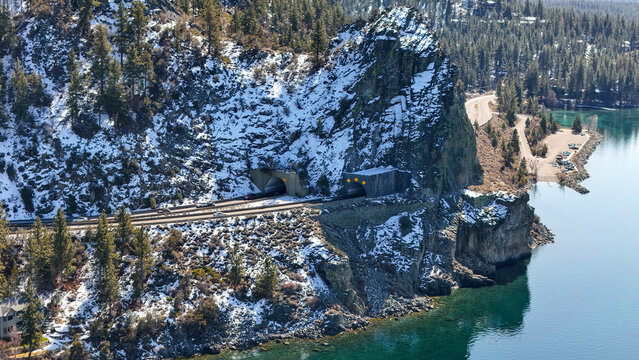 Aerial view of serene Cave Rock with tranquil lake and snow-covered mountains, Glenbrook, Nevada, United States. - Powered by Adobe