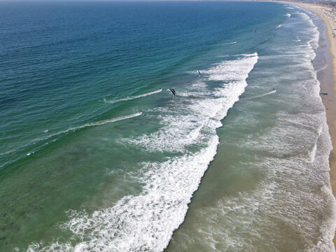 Aerial view of kite surfing on the beautiful ocean waves at the sandy beach, Coronado, California, United States.