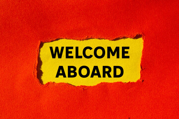 Welcome aboard message written on ripped torn red paper on yellow background. Conceptual welcome aboard symbol. Copy space.