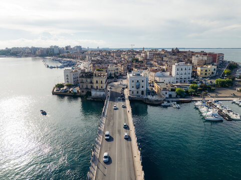 Aerial view of historic architecture and charming buildings along the waterfront with boats in the bay, Taranto, Taranto, Italy.