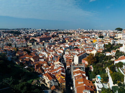 Aerial view of beautiful historic cityscape with red roofs and vibrant rooftops, Graca, Lisbon, Portugal.
