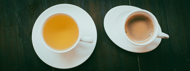 Panorama view Espresso coffee shot and yellow chamomile tea cup with saucers and stainless-steel spoon on wooden table at local coffee shop in Can Tho, Southern Vietnam, porcelain mugs hot drink