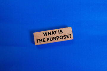 What is the purpose message written on wooden block on blue background. Conceptual what is the...
