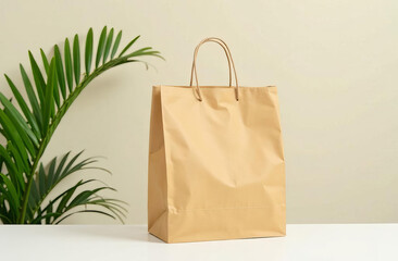 Brown paper shopping bag next to a green plant against a neutral background. Eco-friendly shopping.