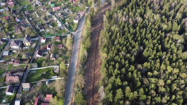Flight over a gas clearing on the edge of a forest in the countryside