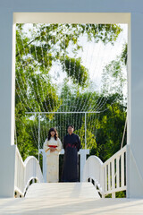 Vertical photo of Couple dressed in traditional yukata and kimono walking together on white wooden...