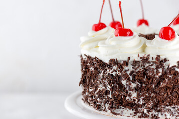 Black forest cake, Schwarzwald pie, dark chocolate and cherry on a light background. Vegan food, sugar, lactose and gluten free.