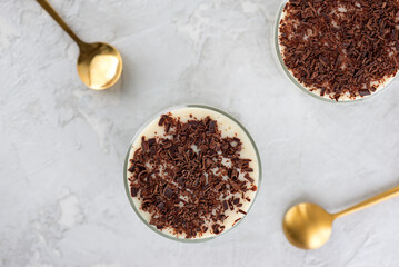 Black forest trifle with cherry, vegan cream and chocolate biscuit on a gray table. Top view.