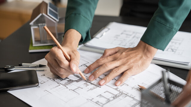 Architecture Man drawing on architectural Creative project business architecture building construction Industrial engineering Achievement Planning Design on eco blueprint