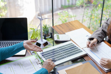Solar panels green energy Business people working in green eco friendly office business meeting...