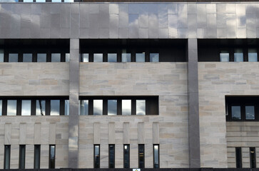 Obraz premium Facade of Modern Office Building with Stone and Metal Cladding 