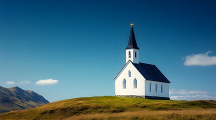 Fototapeta premium Pristine white chapel sits on a verdant hillside under a deep blue sky, its tall spire and simple stone design offering a tranquil, minimalist sanctuary in a rural landscape.