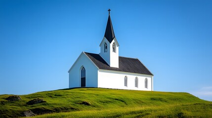 Fototapeta premium Pristine white chapel sits on a verdant hillside under a deep blue sky, its tall spire and simple stone design offering a tranquil, minimalist sanctuary in a rural landscape.