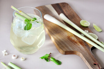 A Glass of Fresh Lemongrass Drink with Ingredient on Wooden Board