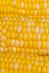 peeled corn cob with yellow and white seeds of different sizes and shades