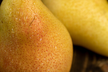 wet ripe yellow red pears on the table