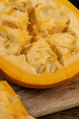 ripe orange pumpkin with seeds cut into pieces