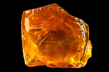 Translucent golden copal resin with natural fractures and smooth glossy surface.