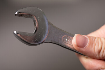 A well-used wrench held in a hand.  Perfect for repair, DIY, and tool concepts.