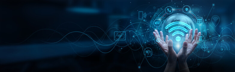 IOT. Hand of man holding a global Internet of Things network connection, smart devices, data exchange, cloud computing, wireless communication, sensors, automation, artificial intelligence.