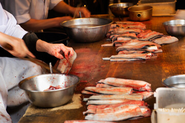 Chef people killing and fillet eel fish for show customer and cooking kabayaki or eel grilled with sweet sauce in Naritasan Omote Sando or Old Japanese Narita town Chiba Prefecture in Tokyo, Japan