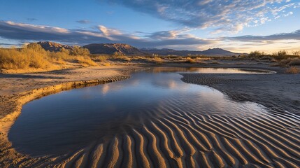 Tranquil desert landscape with reflective pools and distant mountains under a sky with soft clouds