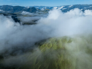 Aerial view of beautiful high altitude grassland mountain in fog landscape