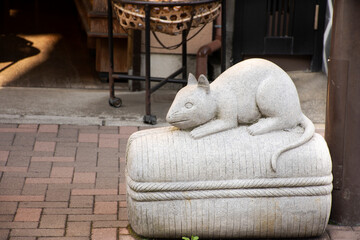 Traditional japanese style rock sculpture and carving as animal stone rat or mouse one of 12 Zodiac at beside street at Narita old town in Tokyo, Japan