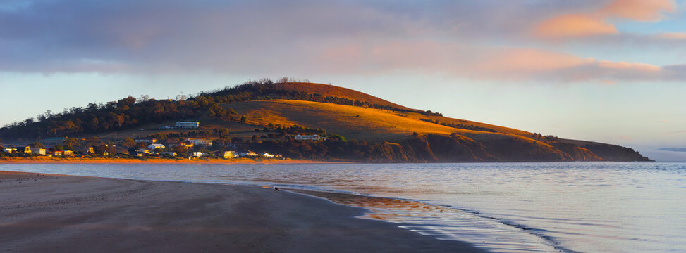 Dawn sunshine striking a mountain at the coast