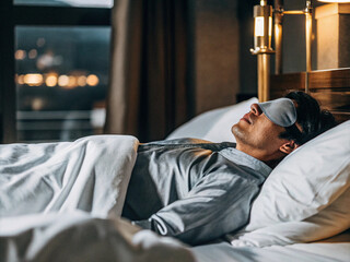 Fototapeta premium A man sleeping with an eye mask. Importance of sleep. Image of good sleep.