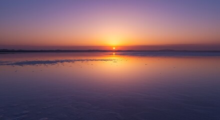 Obraz premium Serene Sunset Over Calm Waters - A breathtaking sunset casts a warm glow over a tranquil body of water, reflecting the vibrant colors of the sky