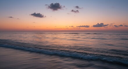Obraz premium Serene Sunset Over Calm Ocean - Peaceful ocean scene at sunset, soft waves lapping the shore under a pastel sky. Tranquil and calming beach view