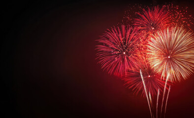 Fototapeta premium spectacular display of fireworks illuminating night sky with vibrant red and gold colors, creating festive atmosphere