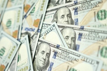 American hundred dollar paper money lies on the office table. Close-up of 100 American dollar bills. Currency exchange one hundred dollars. Investment, finance and income concept.