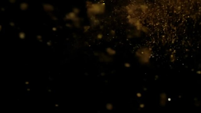 A stunning burst of golden dust particles against a dark backdrop for a dramatic effect.