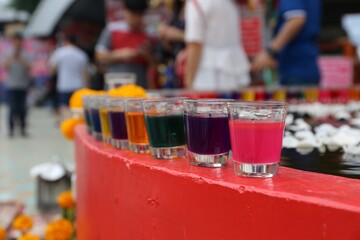 A variety of colorful candles offered in prayer for blessings and good fortune in life.